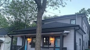 A two-story house with a porch, a tree in front, and a street view. - Rare Find! 6 Bedroom Duplex, Close to Downtown! (Atlanta)