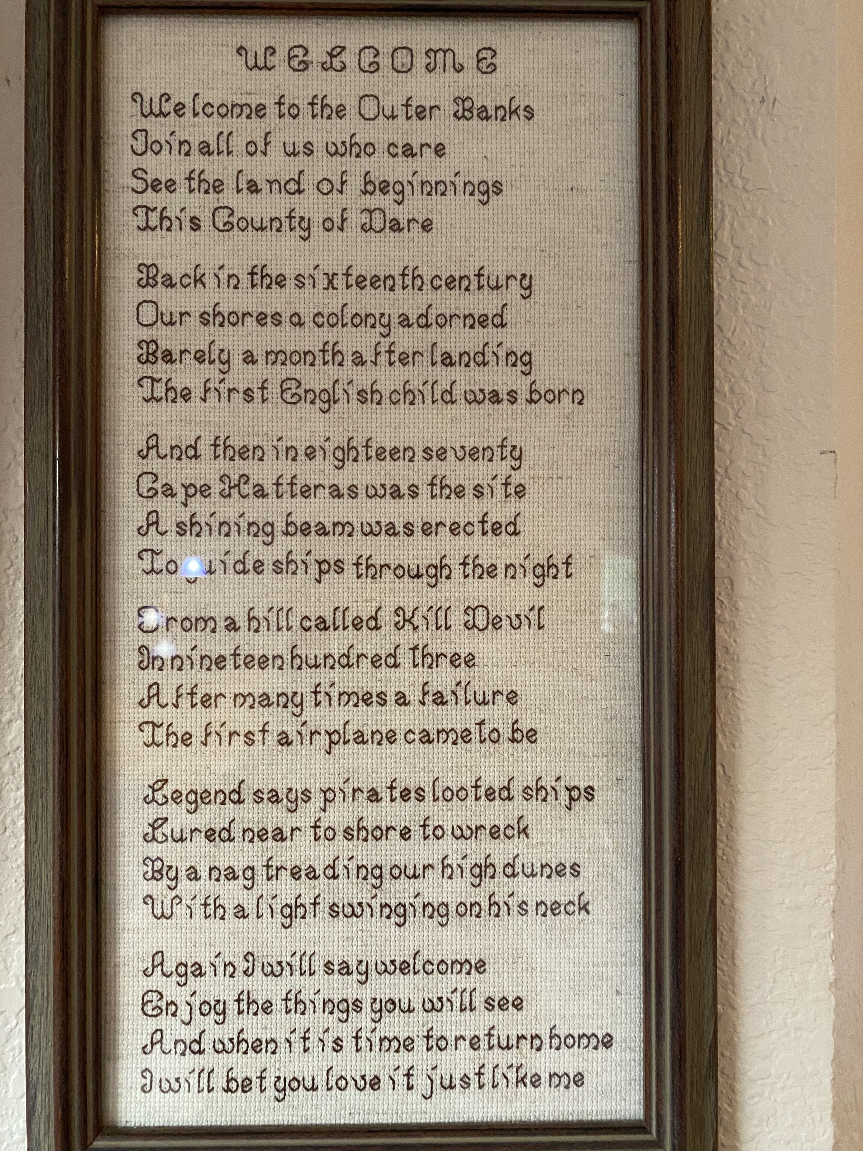 Un letrero de bienvenida enmarcado con texto histórico.