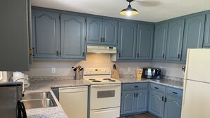 A kitchen with blue cabinets, a white stove, and a granite countertop. - Countryside paradise 6 miles to Stockton Lake! We now have high-speed internet! (Stockton)