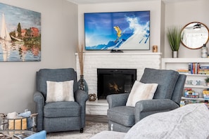 Smart TV, fireplace, table football, books