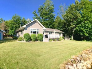 Enjoy a peaceful retreat in this charming single-story home with a porch and beautifully manicured lawn.