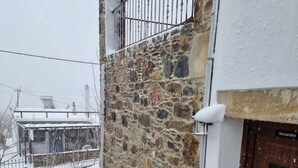 A stone building with a wooden door labeled "Alexander".