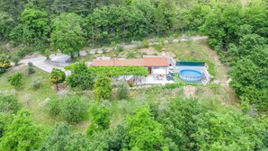 A house with a red-tiled roof, a swimming pool, and a garden area. - Pet friendly home in Kostrcani with WiFi (Kostrcani)