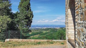 A stone building with a view of a green landscape and distant hills. - 6 bedroom nice home in Montaione (Montaione)
