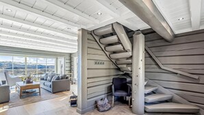 A modern interior with a staircase, a sofa, and a view of the outdoors. - Beautiful home in Rauland with sauna (Rauland)