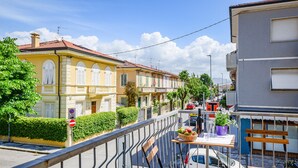 A street view with buildings, a no parking sign, a T-junction, and a table with items on it. - Awesome apartment in Viareggio with WiFi (Viareggio)