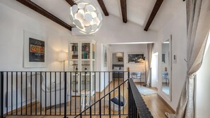 A modern interior with a staircase, a bookshelf, and a dining area. - Beautiful home in Jadranovo (Jadranovo)
