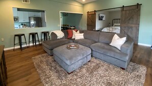 A modern living room with a sectional sofa, a coffee table, and a ceiling fan. - A charming country escape.  Near wineries, SLO, hiking, and SM Ranch & lake. (Santa Margarita)