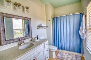 Combined shower/bathtub, towels, soap, toilet paper