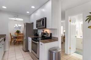 Enjoy cooking in this well-equipped kitchen with a refrigerator, oven, microwave, and dishwasher.