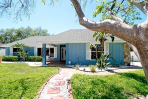 A single-story house with a porch, a mailbox, and a well-maintained lawn.
