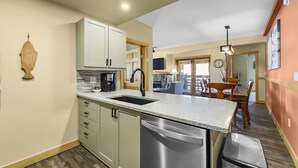 A modern kitchen with a built-in dishwasher, a coffee maker, and a sink. - Luxury Remodeled Passage Point Condo - Short Walk to Lifts - Incredible View - PP403 by Redawning (Copper Mountain)