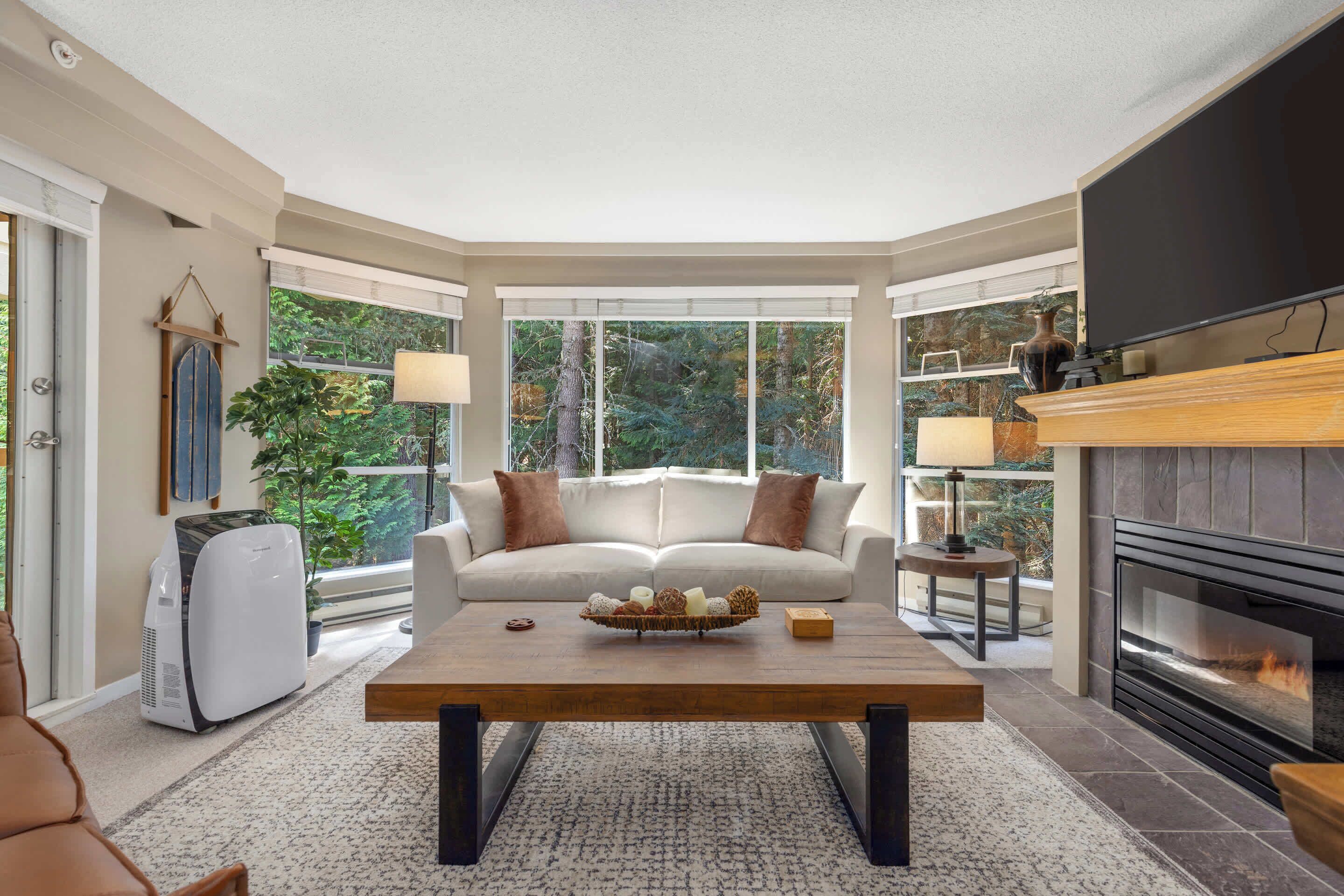 A cozy living room with a fireplace, a sofa, and a coffee table.