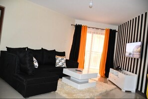 Departamento Deluxe | Sala de estar | Televisión