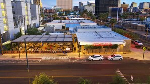A restaurant named Wilderness DTPHX with a covered outdoor seating area and a parking lot. - DTPH Modern Designer Studio - Pool & Parking - (Phoenix)