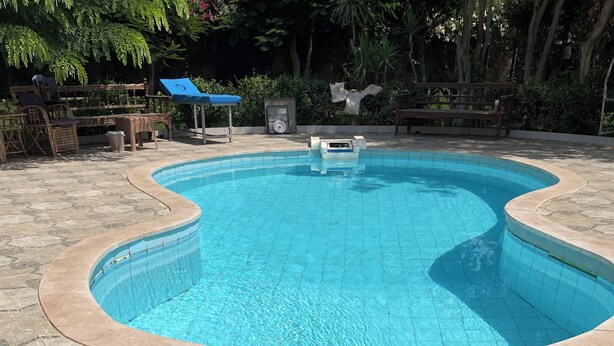 Una piscina con rivestimento in piastrelle e bordo in mattoni.