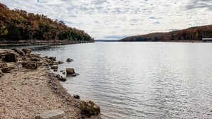 A calm lake with rocky shores and dense forests on both sides. - Next to SDC, walk to Table Rock Lake (Branson)