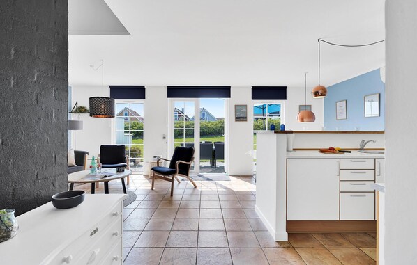 Enjoy a spacious kitchen with white cabinetry and a dining area offering a view of the outdoors.