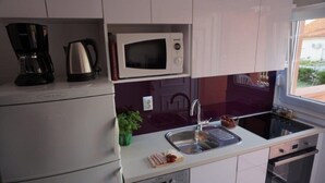 A compact kitchen with a microwave, coffee maker, and a dishwasher. - Modern Studio A4 for 2-3 people with 2 swimming pools (Pag)