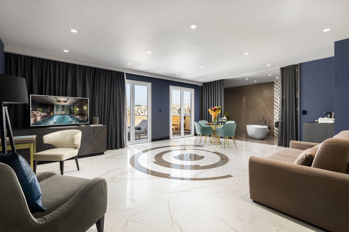 A modern living room with a TV, sofa, and dining area.