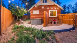 A wooden cabin with a small porch, a hot tub, and a dog house. - Walk to Lake Cabin great for kids &  Pets Spa BBQ WiFi King Bed Ski Free Coffee (Big Bear Lake)