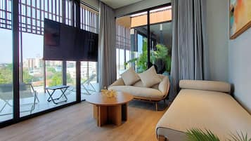 Junior Penthouse, 2 Bedrooms, Hot Tub, Pool View | Living area | 55-inch Smart TV with digital channels