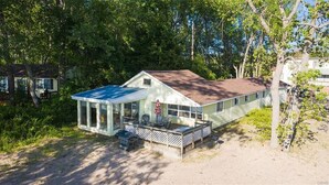 A single-story house with a covered porch and a fenced yard.