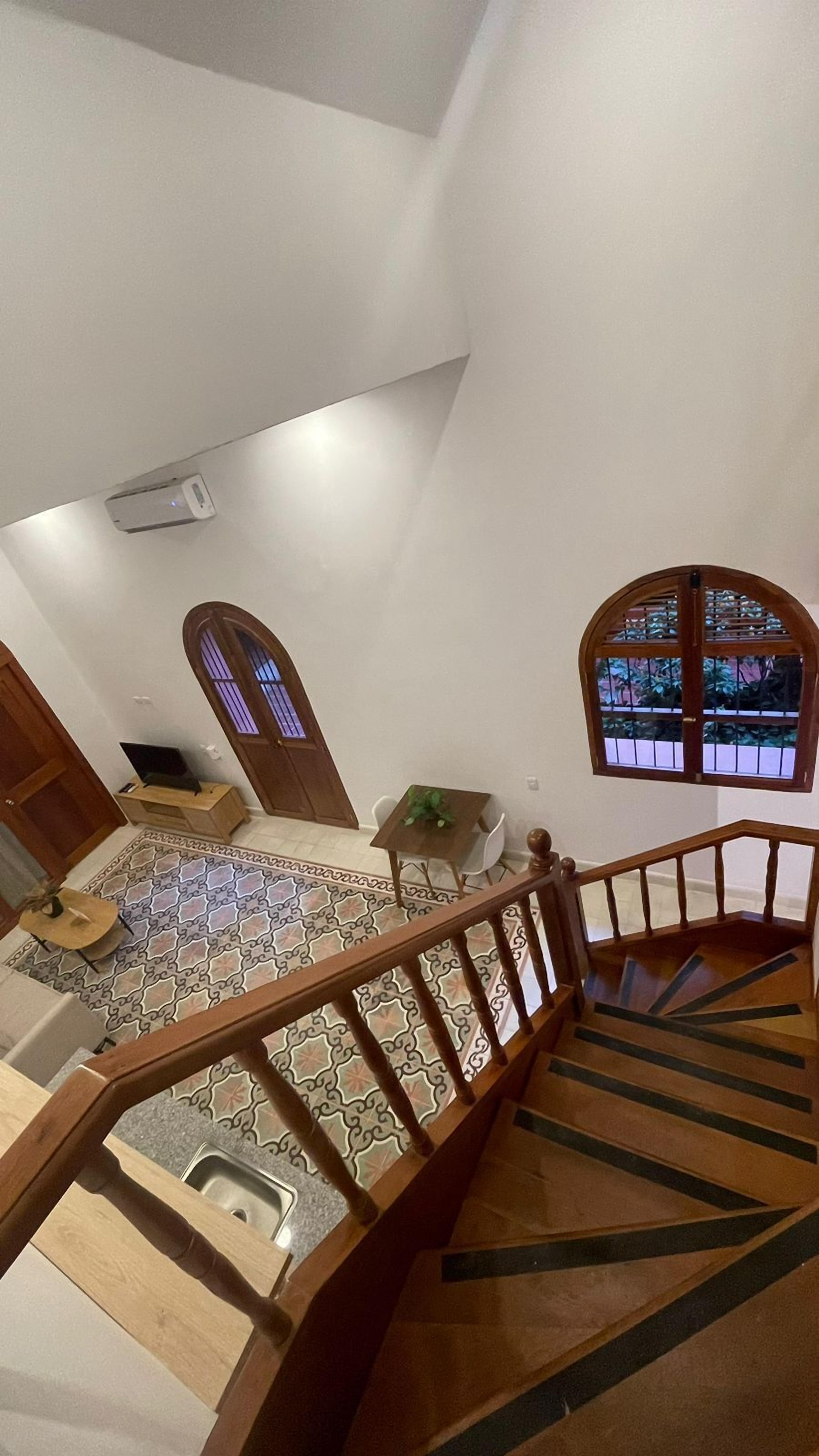 A staircase with wooden railings leading to a lower level.