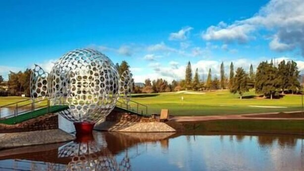 A golf course with a large spherical sculpture in the foreground. - Stylish one bed apartment at Matchroom CountryClub (Las Lagunas de Mijas)