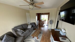 A living room with a grey sofa, wooden coffee table, and a TV on a wooden stand. - BEACHSIDE GETAWAY IN SHEBOYGAN (Sheboygan)