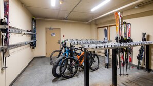 A ski storage area with racks for skis and a table for snowboards. - Ski in, Ski out Fireside Retreat  (Sun Peaks)
