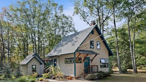 A two-story cabin with a sloped roof, a front porch, and a small attached garage. - Brand new year round house with easy access to to everywhere in Ogunquit (Ogunquit)
