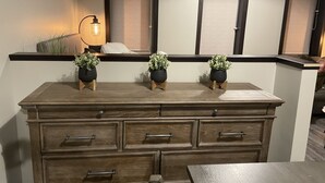 A wooden dresser with drawers and a shelf, topped with three potted plants. - NEW, NEW, NEW!  Wabasha downtown studio113 Pembroke Ave Unit #102 (Wabasha)