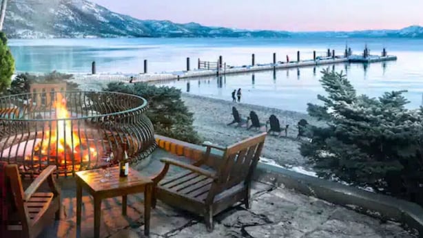 A lakeside seating area with a fire pit, wooden chairs, and a view of a dock extending into the water. - 2 bedroom Condo at Hyatt Lake Tahoe - May 29th - June 4th (Incline Village)