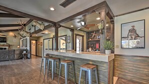 A spacious kitchen with a central island, wooden beams, and a ceiling fan. - Desert Oasis with Pool, Fire Pit, Game Room, and Dry Bar (Borrego Springs)
