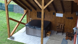 A wooden structure with a lofted sleeping area, a small wooden bench, and a lantern. - Le Chalet au Vieux Vignoble, a spacious cottage in Alsace near Saverne, offers c (BOUXWILLER)