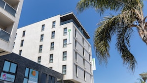 A modern hotel with a white facade, multiple balconies, and a visible sign for 'Holiday Inn Express'. - Holiday Inn Express Ajaccio by IHG (Ajaccio)