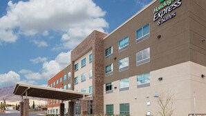 A Holiday Inn Express building with a covered entrance, multiple windows, and a clear sky. - Holiday Inn Express and Suites El Paso North by IHG (El Paso)