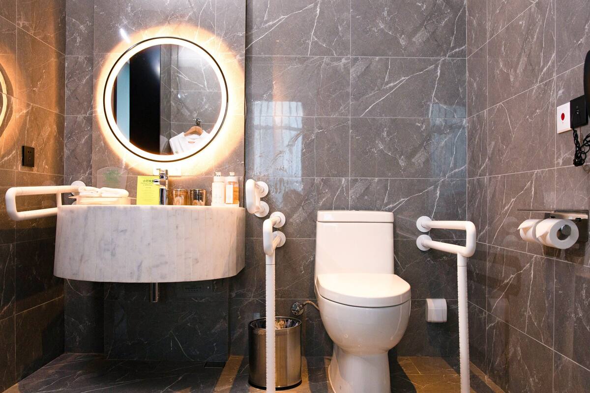 Une salle de bain moderne avec un lavabo en marbre, des toilettes et un bidet.