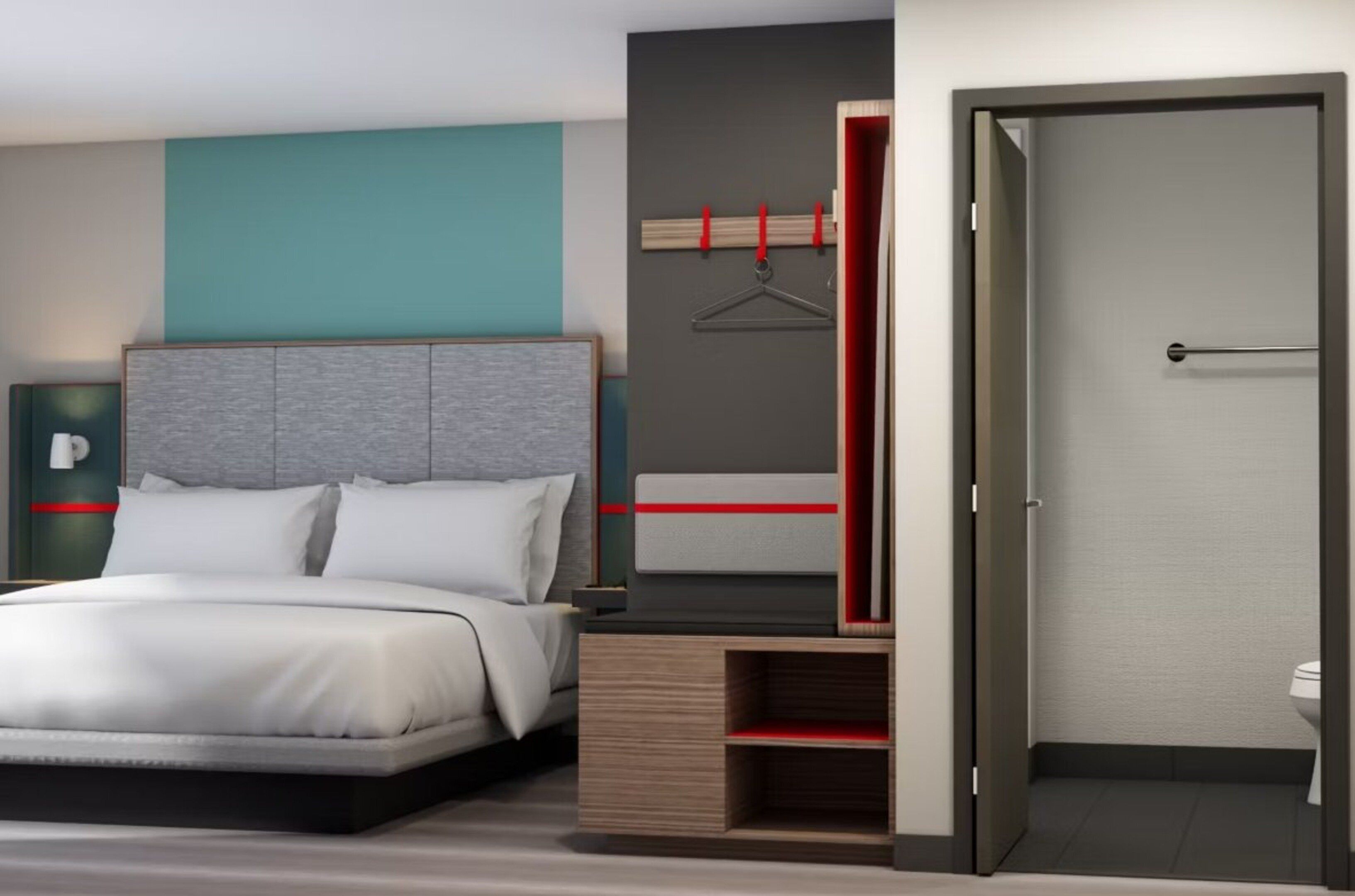 A modern hotel room with a bed, a wardrobe, and a bathroom.