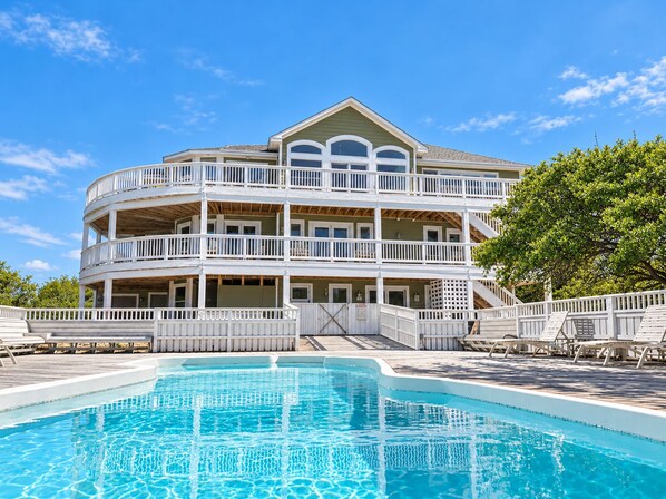 A multi-story building with a pool in front. - Corolla Oceanfront 14BR Estate | Pool, Elevator, Pet-Friendly | Sleeps 30 (Corolla)