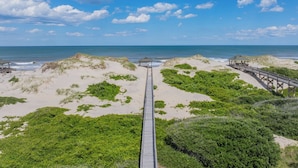 A beach with a wooden boardwalk leading to a gazebo. - Oceanfront Estate | 14BR | Private Pool & Hot Tub | Sleeps 32 (Corolla)