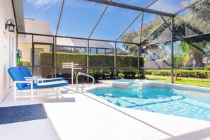 A covered swimming pool with blue lounge chairs and a ladder. - Fun Packed 5 Bedroom Villa with Private Pool/Spa, Games Room & Grill (Kissimmee)