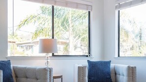A modern living room with two sofas, a small side table, and a fluffy rug. - Amazing Beach House w/ Jacuzzi and Fire Pit (Aptos)