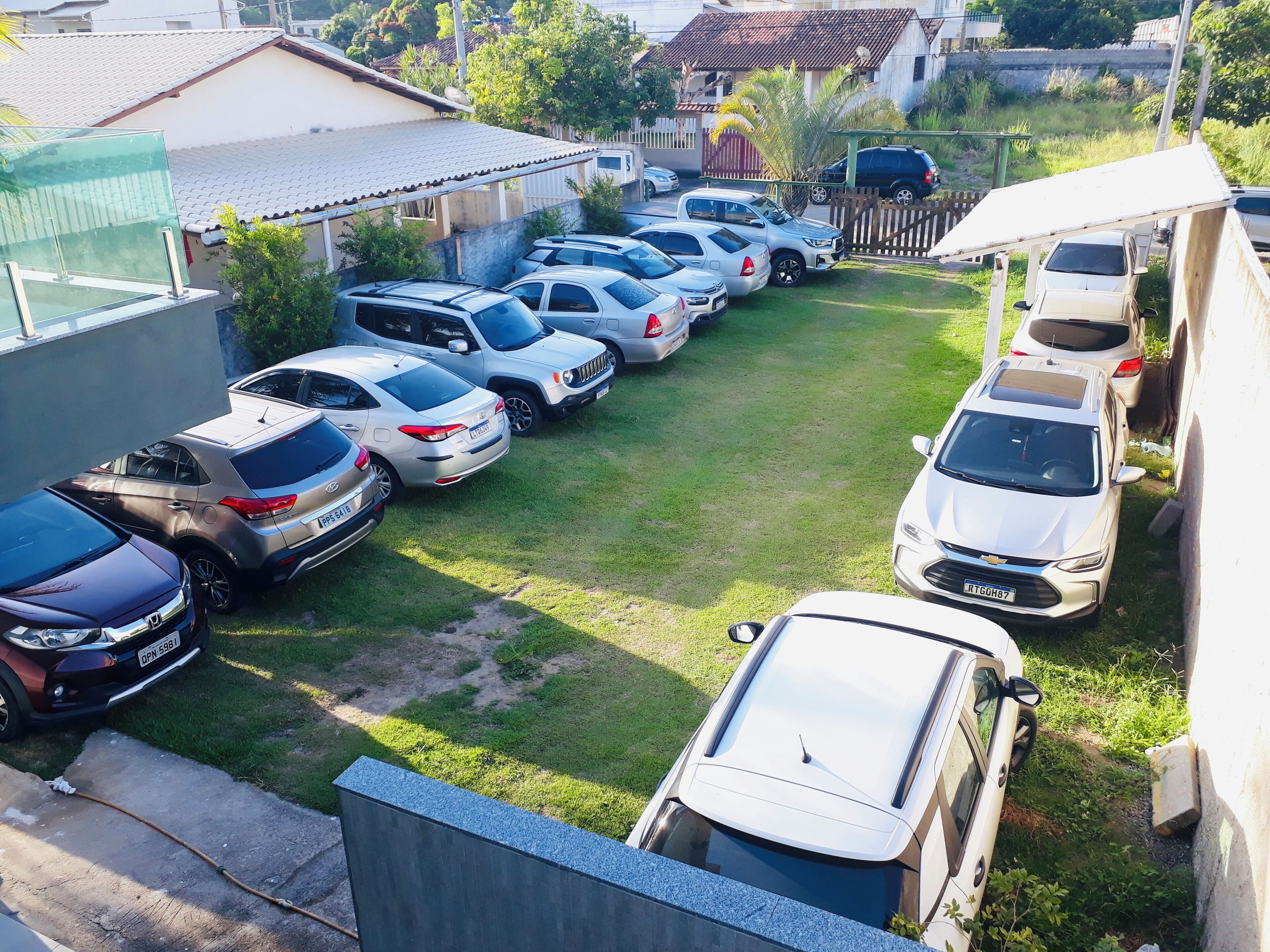 A parking lot with multiple cars parked in rows.