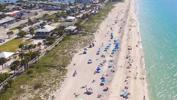 An aerial view of a beach with umbrellas and people. - NewToVRBO RELAX- Own Home Private Pool, Hot Tub, near Beaches, Golf & Pickleball (Rotonda West)