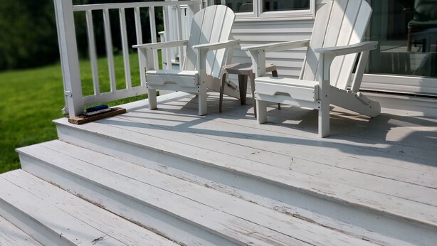 A white deck with two Adirondack chairs and a small table. - Farmstay, 2 bedrooms with 2 private baths, private entrance. (Waldoboro)