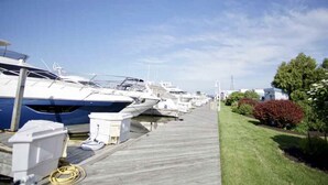 A marina with boats docked along a wooden walkway.