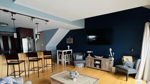 A modern living room with a sofa, coffee table, and a TV.