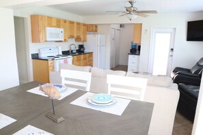 Cozy living space with a kitchenette, dining table, and comfortable seating area.